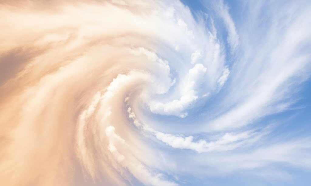 暖かい空気と冷たい空気が出会う境目を表現した実写風イメージ。日本の空に赤と青の空気層が交わり、前線の仕組みを教育的に伝える構図。