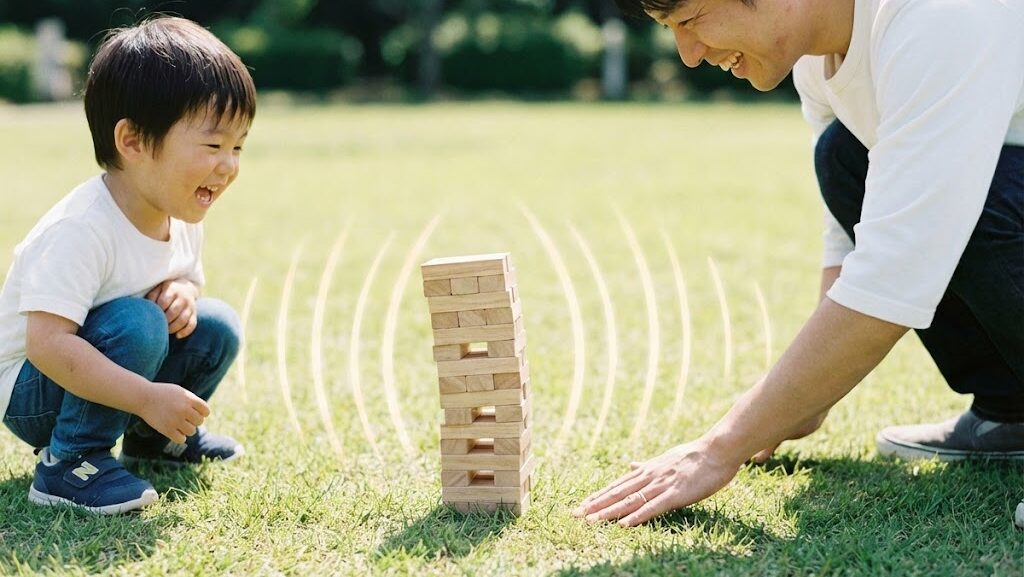 周期1秒台の揺れの大きさを積み木で体験する親子の実写風写真
